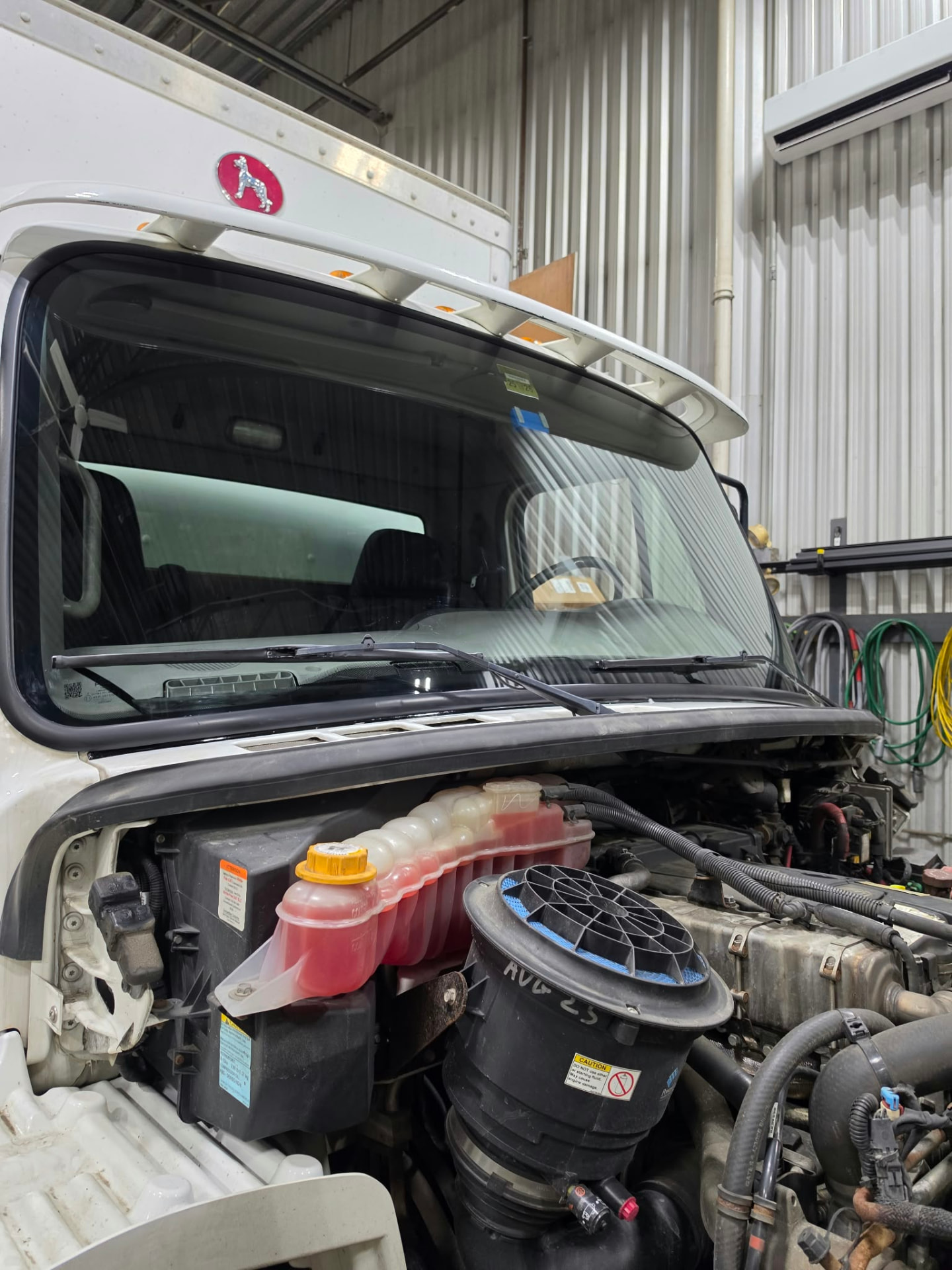White commercial truck windshield in a workshop